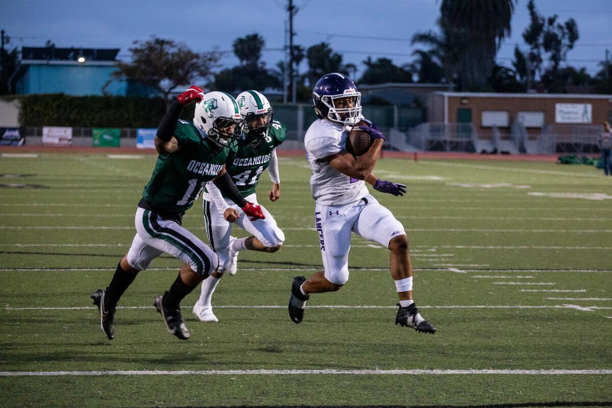 Carlsbad running back Mazlo Norwood scores one of his two touchdowns against Oceanside.