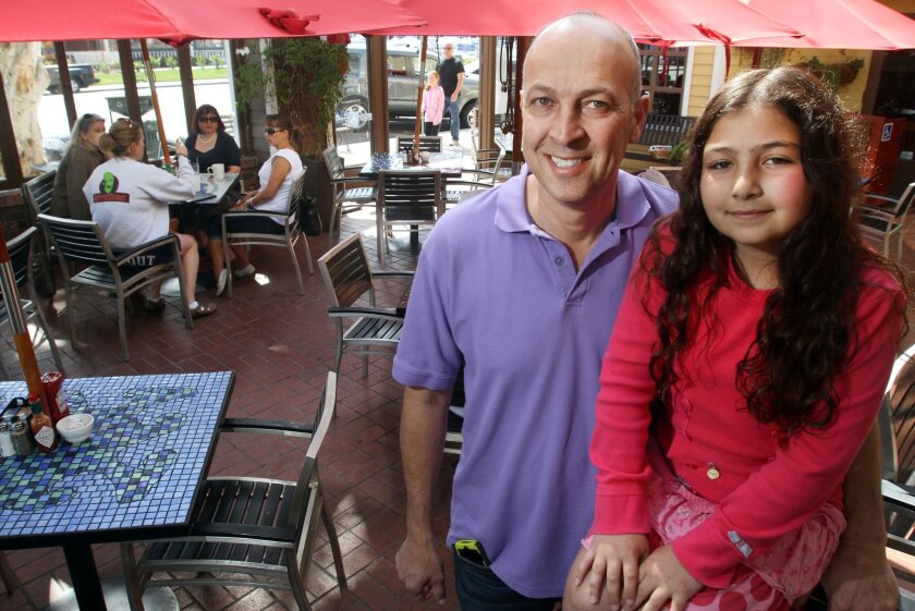 St. Germain's restaurant in Encinitas owner Roy Salameh with his daughter Emily, 9, at the restaurant Wednesday.