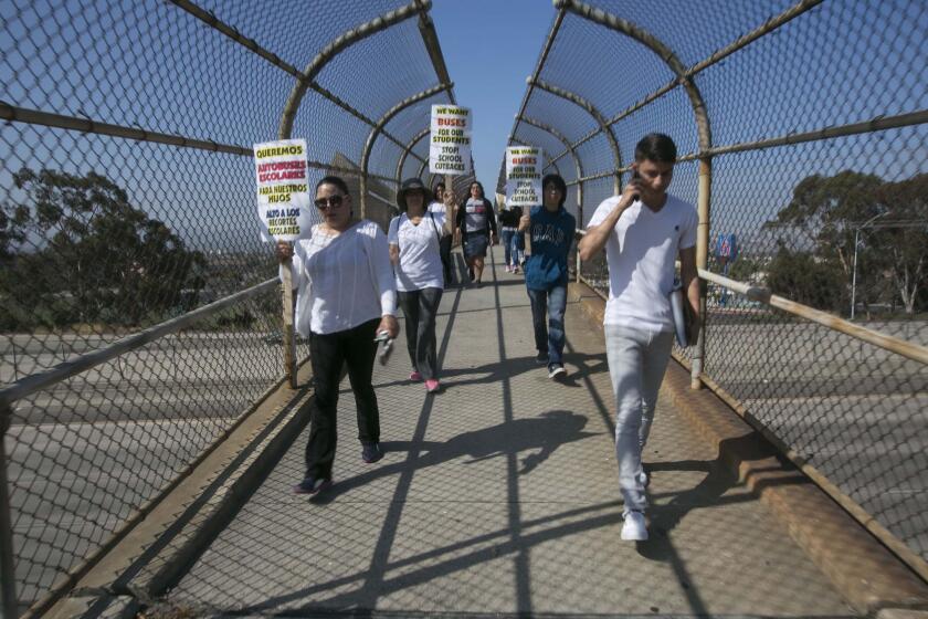 Minerva Downey, left, and her son Paul Downey, a senior, walked the more than three miles from central San Ysidro to San Ysidro High School on Tuesday July 16 2019 to draw attention to the fact that without bus service, which the district has axed, students could have to walk more than six miles to get to classes.