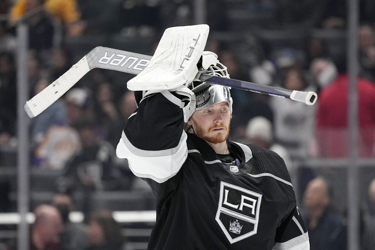 Kings goalie Joonas Korpisalo puts his mask back on after a timeout in a game against the St. Louis Blues on March 4.