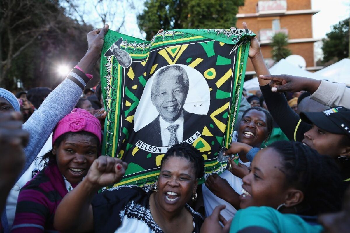 Supporters of Nelson Mandela gather in Pretoria, South Africa, where he was being treated for a lung infection in June. The former South African president died Thursday at the age of 95.