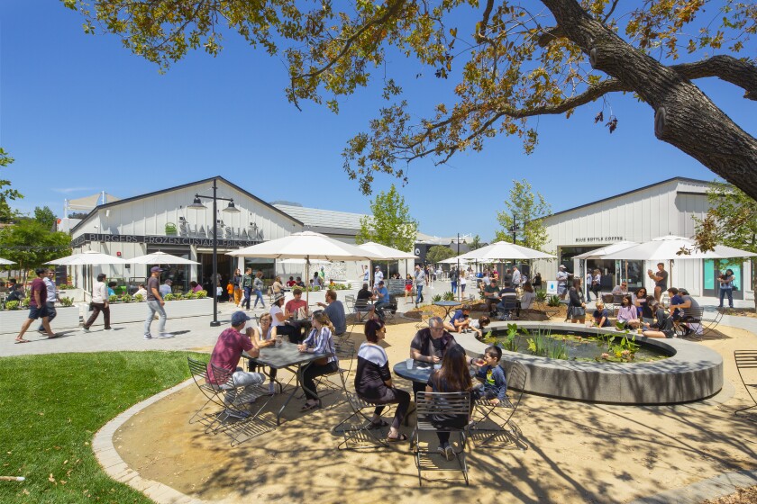 One Paseo visitors relax near the koi pond in the retail area of the 23-acre mixed-use development in Carmel Valley.