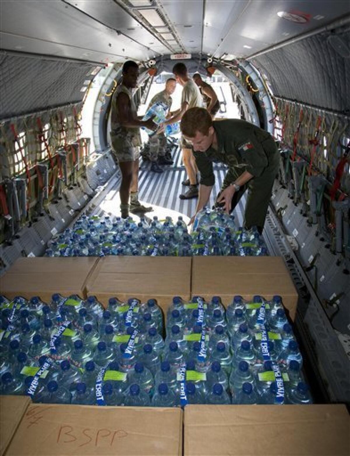 This photo provided Sunday Jan.17, 2010 by the French Defense Ministry shows a French military plane loaded with bottles of water before heading to Haiti Saturday Jan.16, 2010 from the French Caribbean island of Martinique as part of France's emergency aid for the earthquake hit country. (AP Photo/Cyril Amboise/French Defense Ministry/ECPAD) NO SALES
