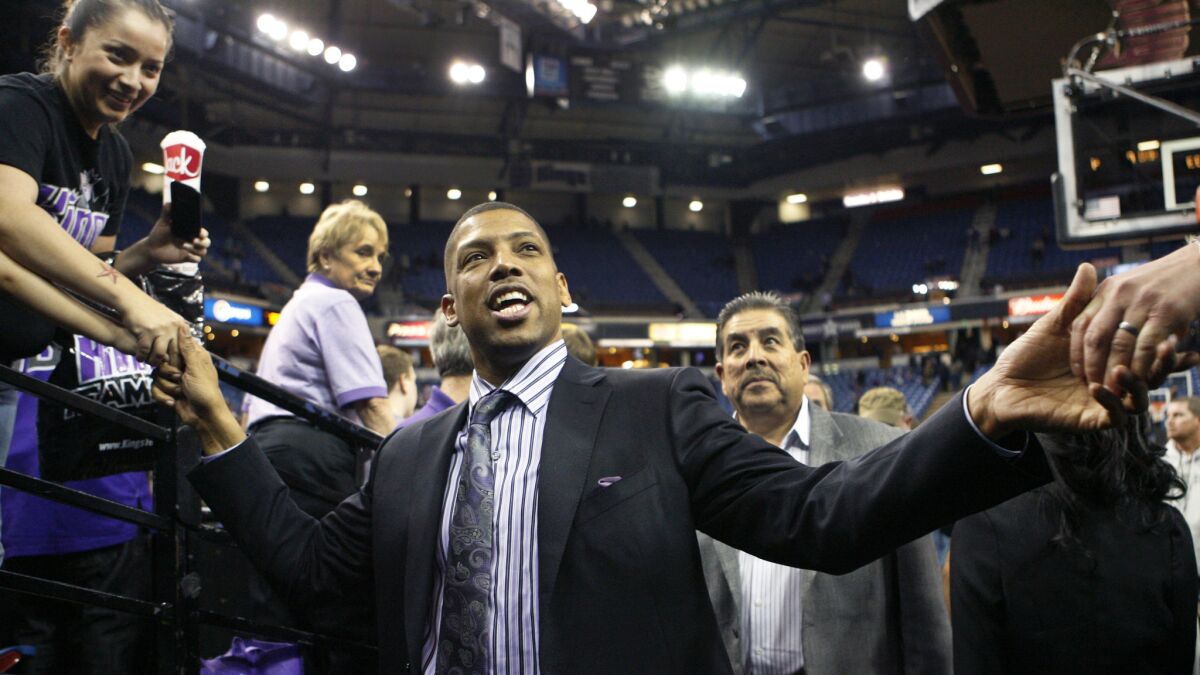 Former NBA player and current Sacramento Mayor Kevin Johnson greets fans during a game against the Utah Jazz in 2012. The Sacramento City Council approved a financial plan for the Kings on Tuesday that would allow the franchise to embark on the construction of a new downtown arena.