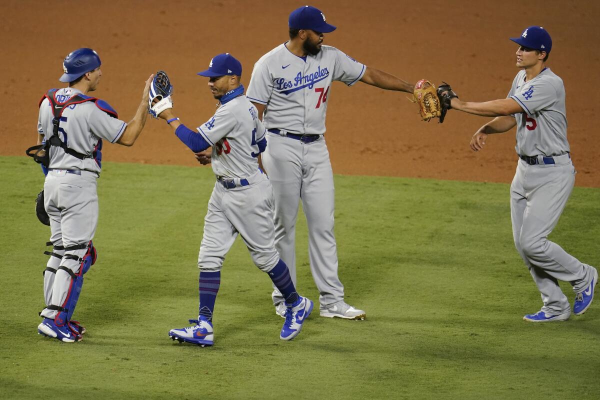 Austin Barnes, left, Mookie Betts, Kenley Jansen and Corey Seager celebrate the Dodgers' win over the Angels.