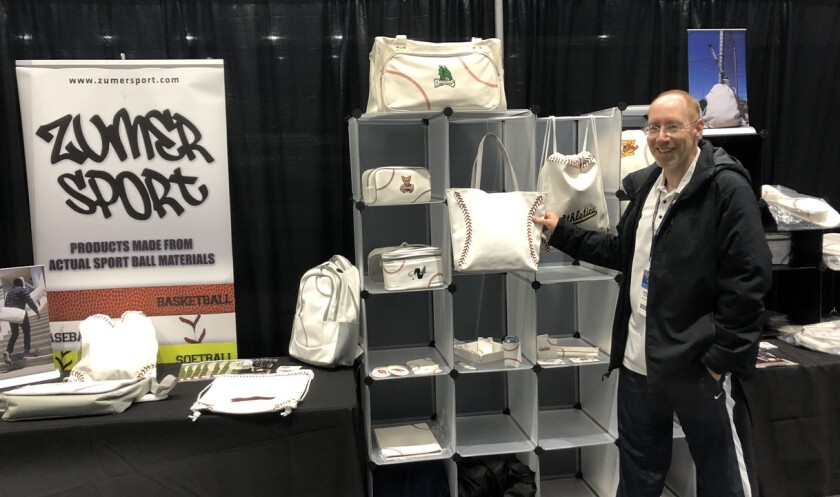 Dan Hock, president and CEO of Zumer Sport, displays products that feature baseball stitching at the Baseball Trade Show.