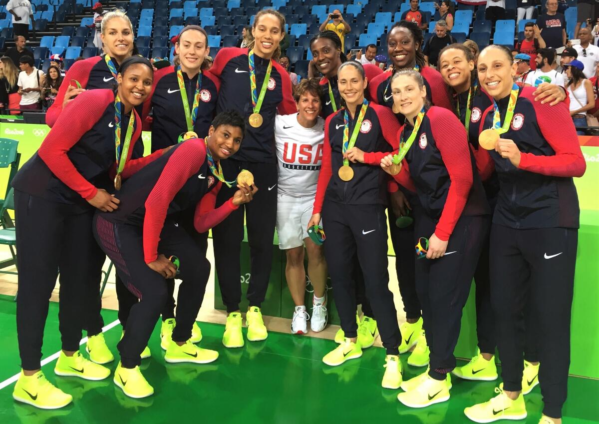 Ilene Hauser, center, poses for a photo with the U.S. national basketball team at the Rio Olympics in 2016.