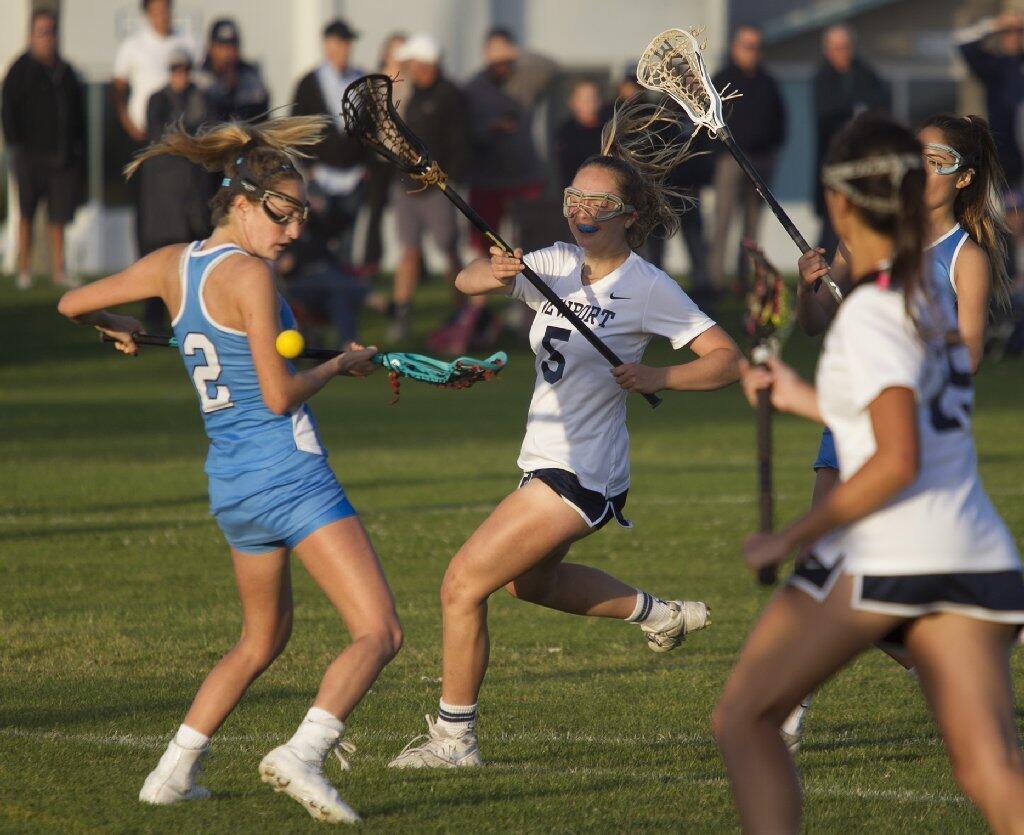 Corona del Mar High's Kennedy Mulvaney (2) breaks up a play on Newport Harbor's Adena Rothbard during the Battle of the Bay.