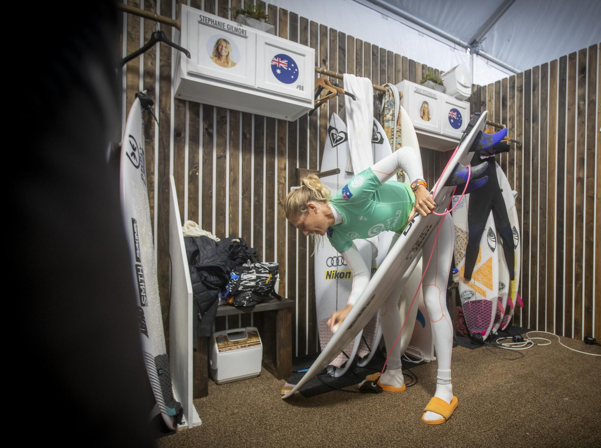 Stephanie Gilmore of Australia waxes up her board at the WSL Finals