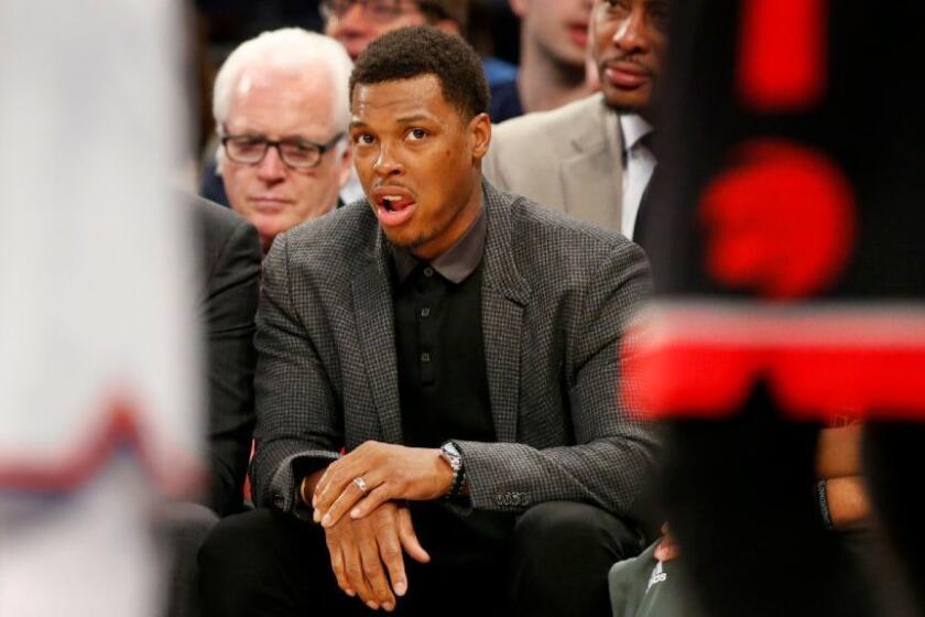 Raptors guard Kyle Lowry holds his right wrist as he watches from the bench during the first half on Feb. 27, 2017. Lowry is scheduled to have wrist surgery Tuesday.