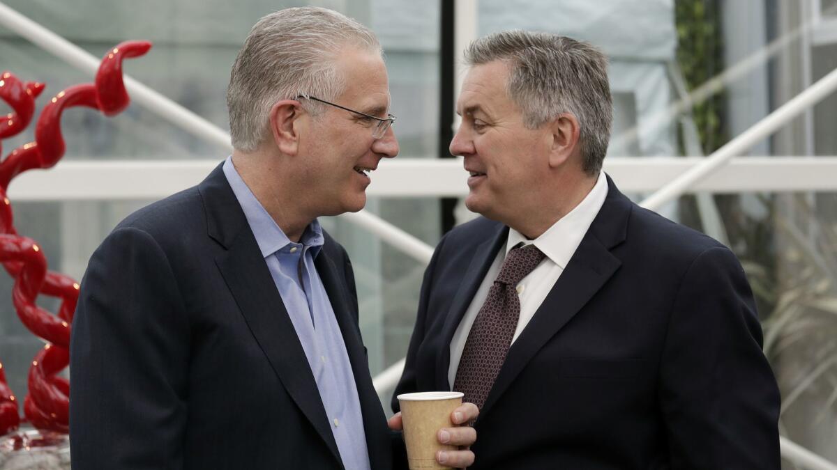 Tod Leiweke, left, chats with his brother, Tim, following a 2018 news conference naming Tod as president and CEO of the NHL expansion team in Seattle.