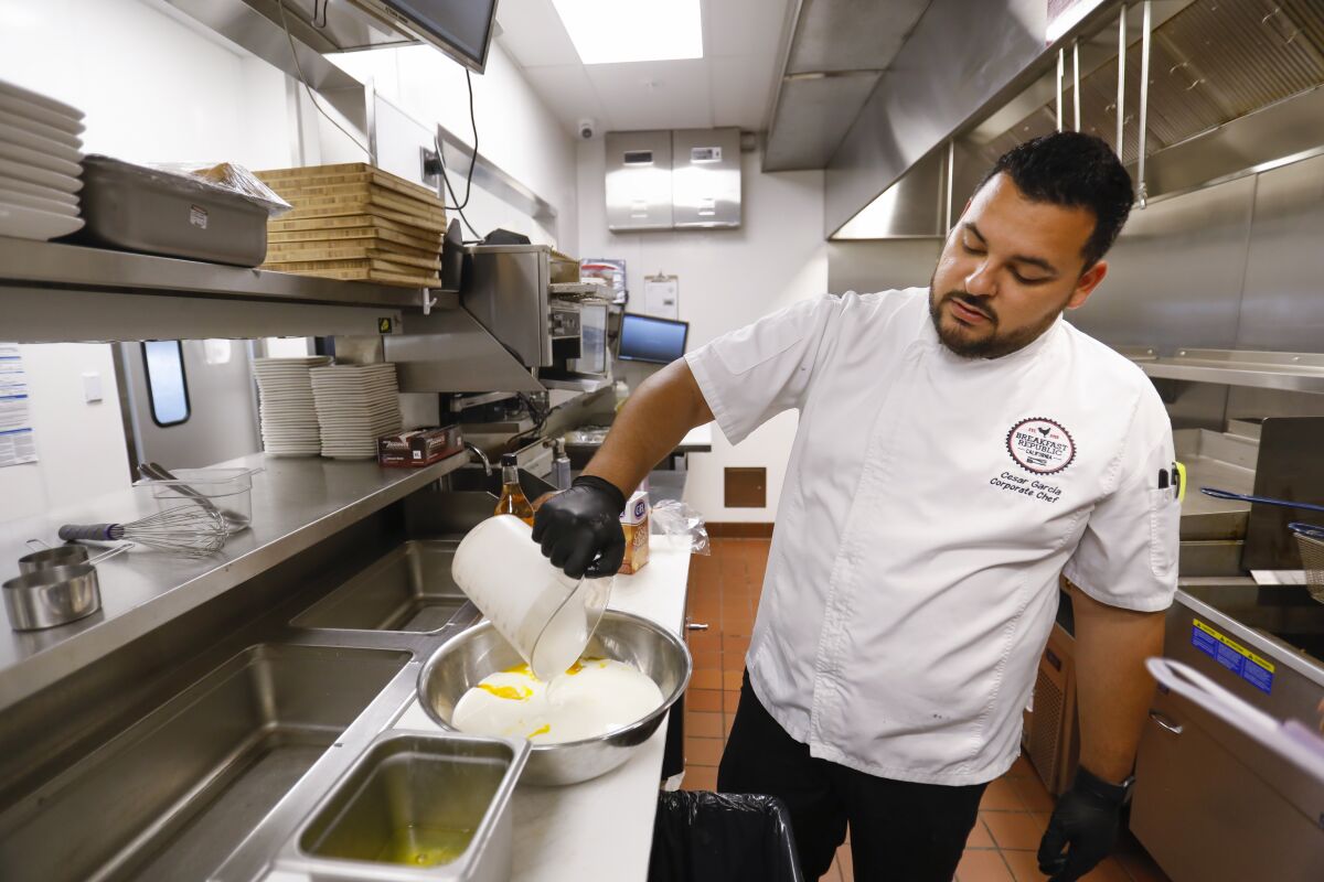 Cesar Garcia, executive chef at Breakfast Republic, prepares Mr. Presley French Toast.