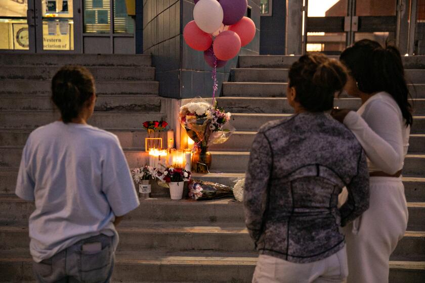 LOS ANGELES, CA - SEPTEMBER 15: Students and community members pay their respects by placing flowers and candles on the steps of Helen Bernstein High School where a teenage girl died of an overdose on Thursday, Sept. 15, 2022 in Los Angeles, CA. (Jason Armond / Los Angeles Times)