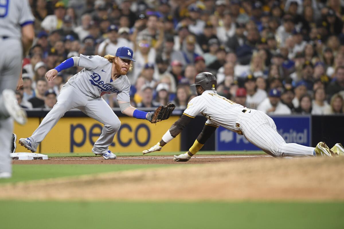 Justin Turner holds his glove near Jurickson Profar as Profar slides head-first.