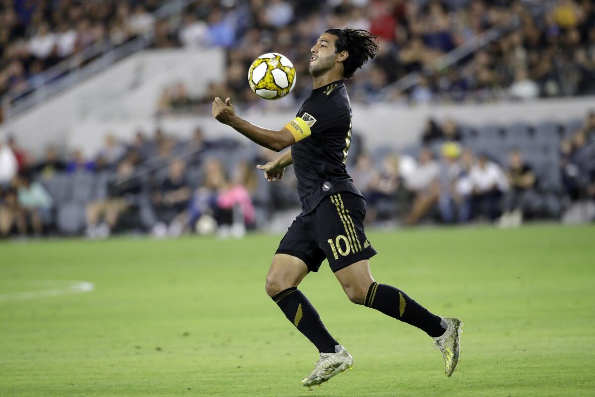 Los Angeles FC's Carlos Vela traps the ball with his chest during the first half of an MLS soccer match against Toronto FC Saturday, Sept. 21, 2019, in Los Angeles. (AP Photo/Marcio Jose Sanchez)