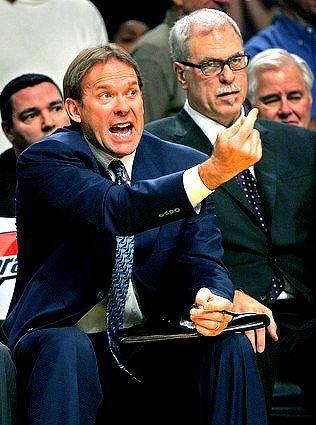 Then-Lakers assistant Kurt Rambis, left, yells from the bench as Coach Phil Jackson looks on in 2009.