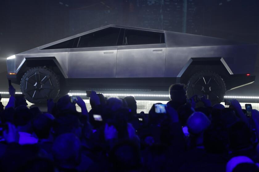 The Tesla Cybertruck is unveiled at Tesla's design studio Thursday, Nov. 21, 2019, in Hawthorne, Calif. CEO Elon Musk is taking on the workhorse heavy pickup truck market with his latest electric vehicle. (AP Photo/Ringo H.W. Chiu)