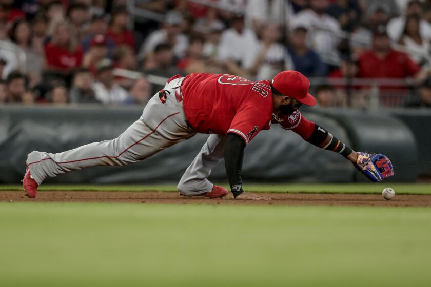 Angels third baseman Jonathan Villar bobbles a ball hit by the Braves' Dansby Swanson during the fourth inning July 23, 2022.