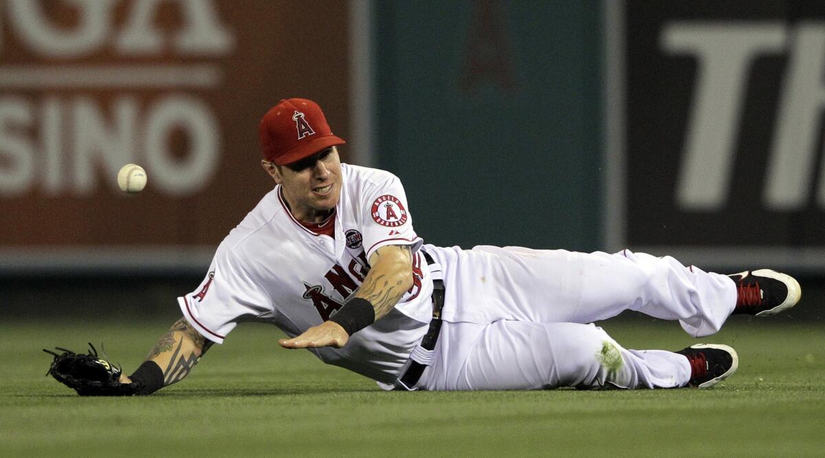 Angels right fielder Josh Hamilton can't make a sliding catch on a double hit by Seattle's Kyle Seager on June 20. Hamilton has fallen hard and fast since landing in Anaheim.