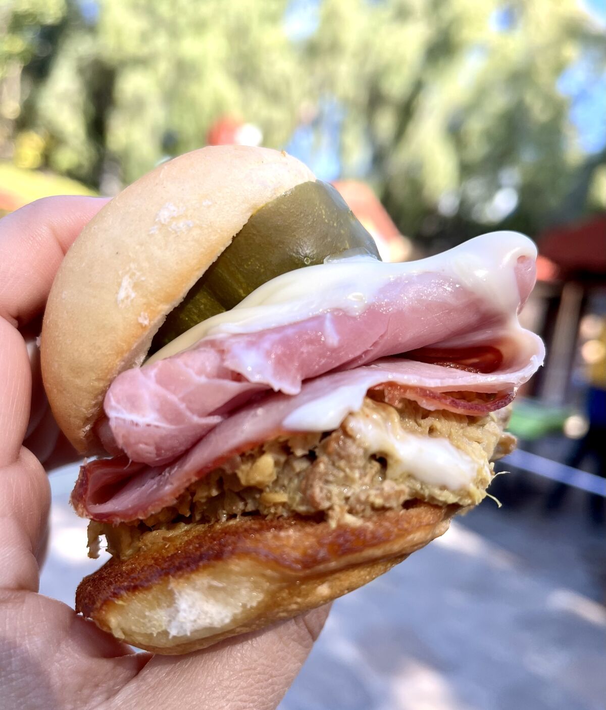 A Cubano slider with slow-roasted, mustard-crusted pork and sliced smoked ham from D*Lish.