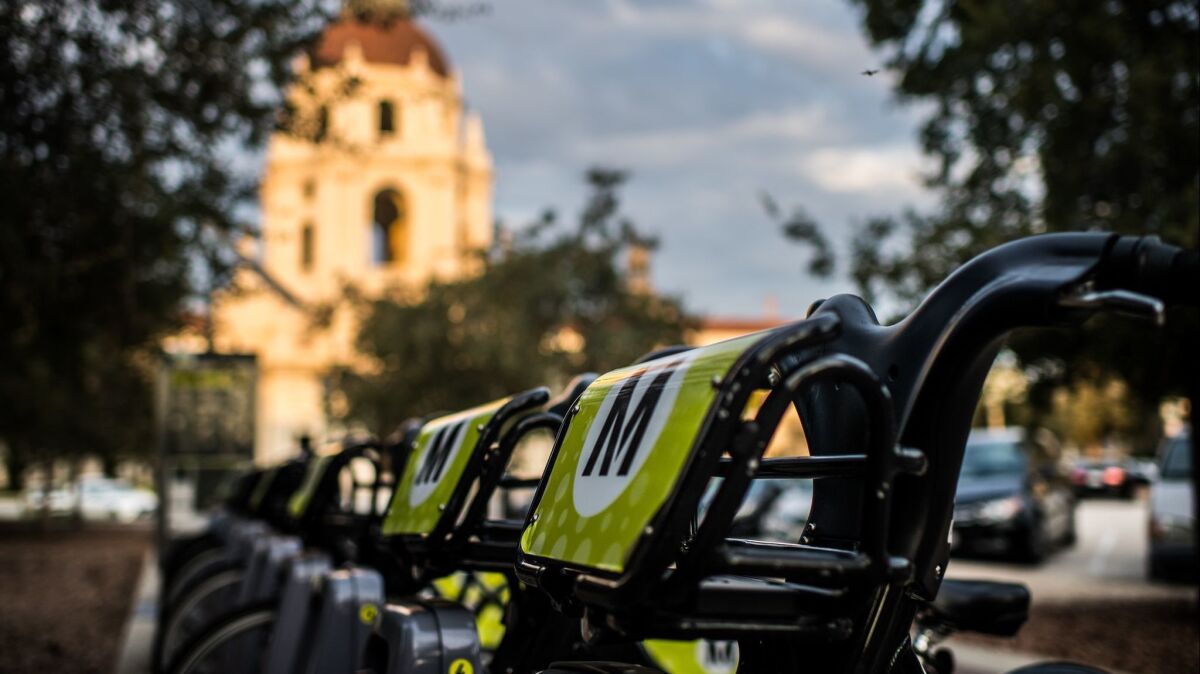 A row of Metro bikes sits outside Pasadena City Hall. Officials there are terminating their bike-share contract with Metro after one year, saying low ridership did not justify the cost.