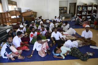 Rohingya refugees rescued from a capsized boat rest at a temporary shelter in Meulaboh, Friday, March 22, 2024. Rescuers pulled out dozens of survivors who had been standing on the hull of the capsized boat on Thursday. (AP Photo/Reza Saifullah)