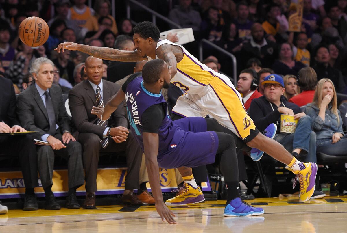 Lakers guard Lou Williams collides with Hornets forward Michael Kidd-Gilchrist during a Jan. 31 game at Staples Center.