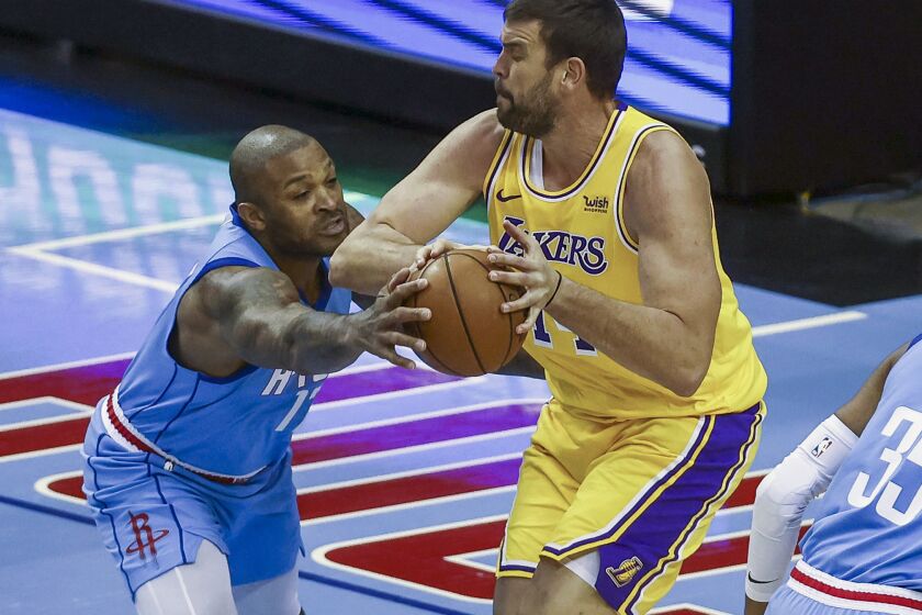 Rockets forward P.J. Tucker tries to steal the ball from Lakers center Marc Gasol on Jan. 21, 2021, in Houston.
