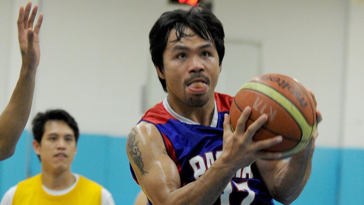 Boxing star Manny Pacquiao takes part in a Philippine Basketball Assn. practice session on Friday.