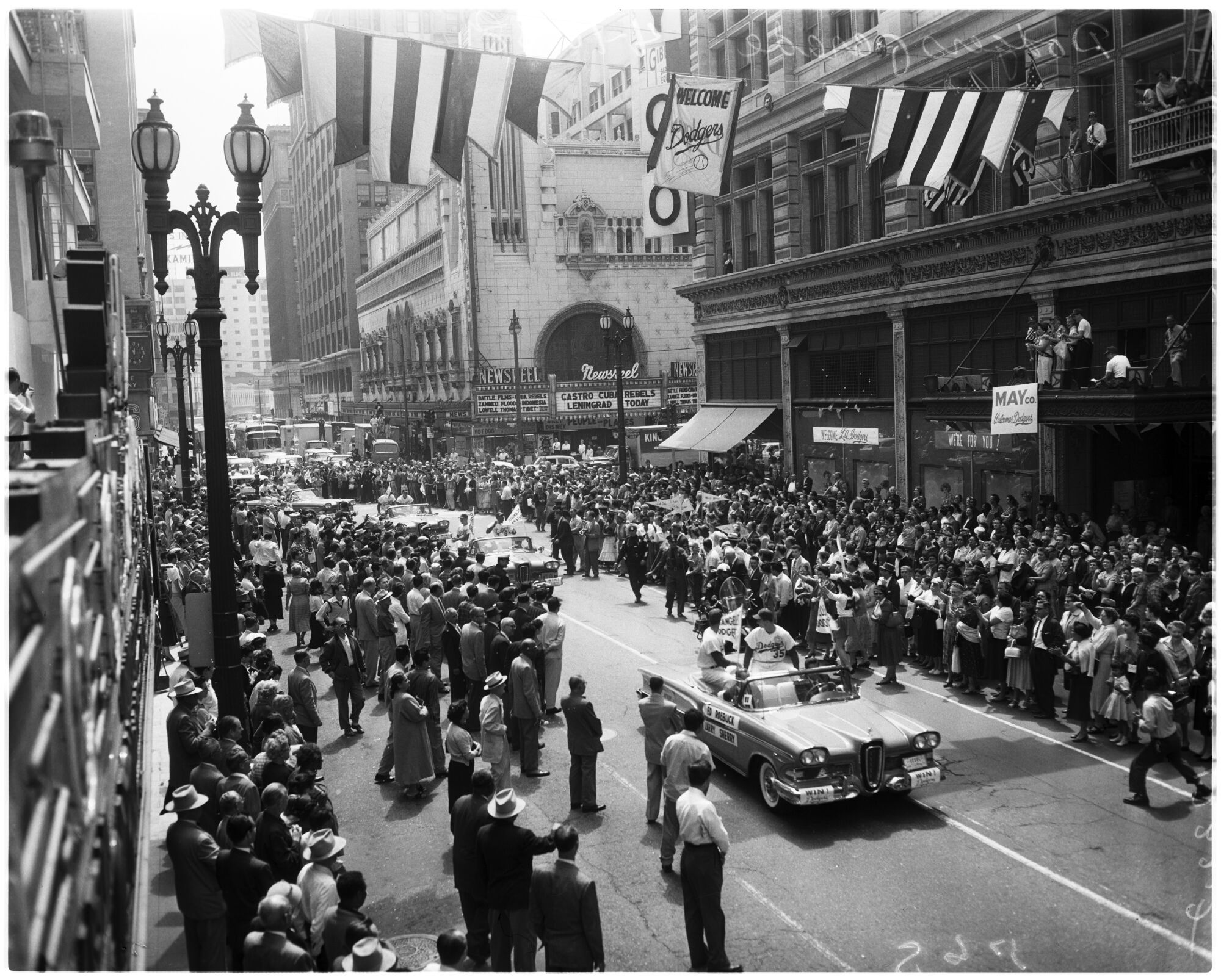 A vintage black-and-white image shows people lining Broadway in downtown Los Angeles to welcome the Dodgers.
