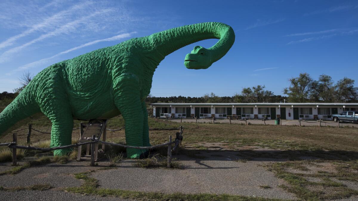 A roadside dinosaur calls attention to The Caverns Inn motel. (Brian van der Brug / Los Angeles Times)