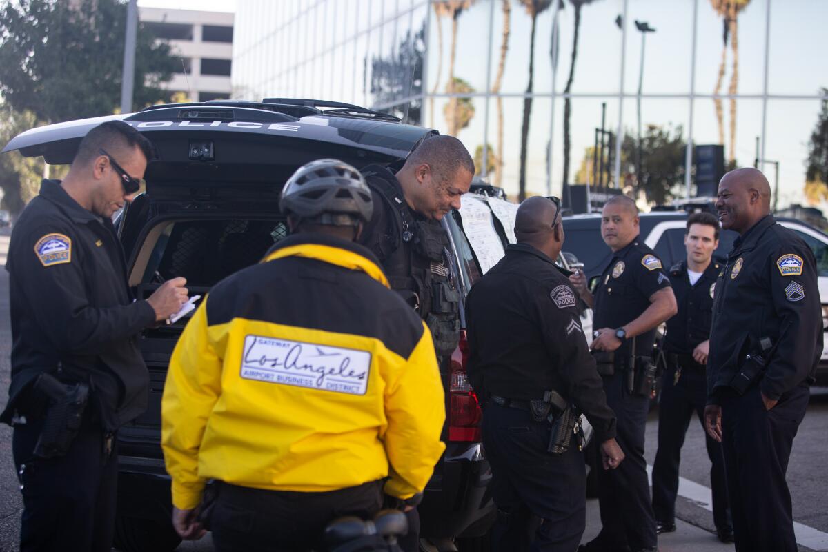 Officers take a statement from Tyrone Tatte, 34, a guard at GatewayLA Business District who reported a suspicious item.
