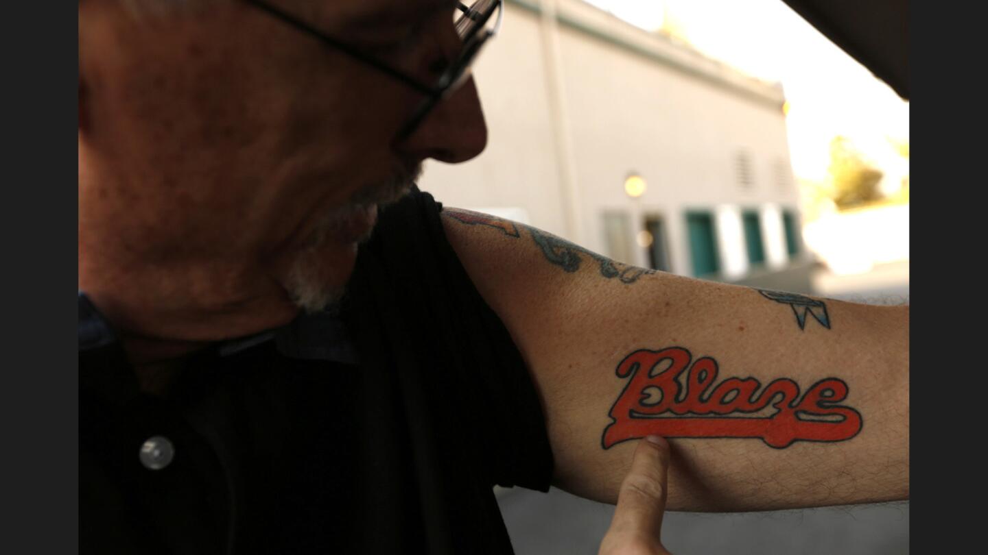 Official scorer Tim Wheeler, 58, shows off his Blaze tattoo before a gameagainst the Stockton Ports. Wheeler has been the team's official scorer for the last 22 years witha streak of 1,439 games in a row as of Aug. 26.