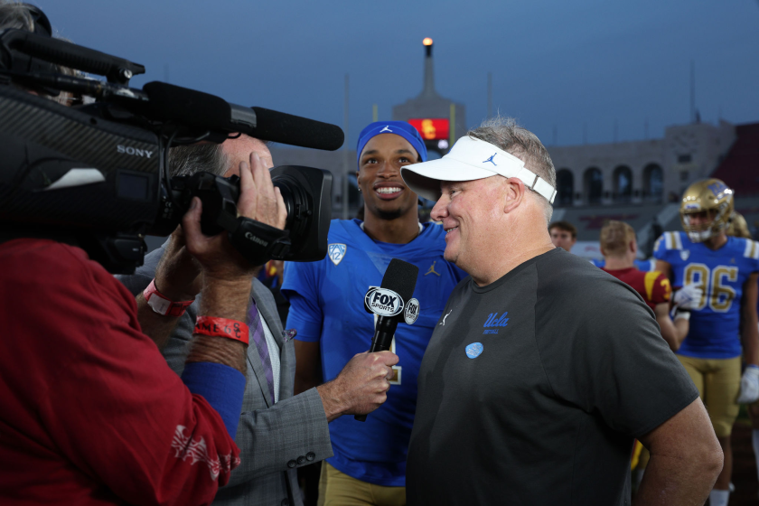 UCLA coach Chip Kelly and quarterback Dorian Thompson-Robinson grin as they interviewed after beating rival USC.