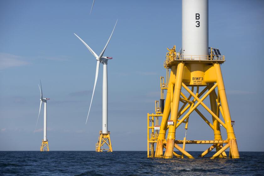 FILE - In this Aug. 15, 2016 file photo, three of Deepwater Wind's five turbines stand in the water off Block Island, R.I, the nation's first offshore wind farm. Interior Secretary Deb Haaland says the Biden administration will hold lease sales for up to seven offshore wind farms on the East and West coasts and in the Gulf of Mexico in the next four years. The projects are part of the administration's plan to deploy 30 gigawatts of offshore wind energy by 2030, generating enough electricity to power more than 10 million homes. (AP Photo/Michael Dwyer, File)