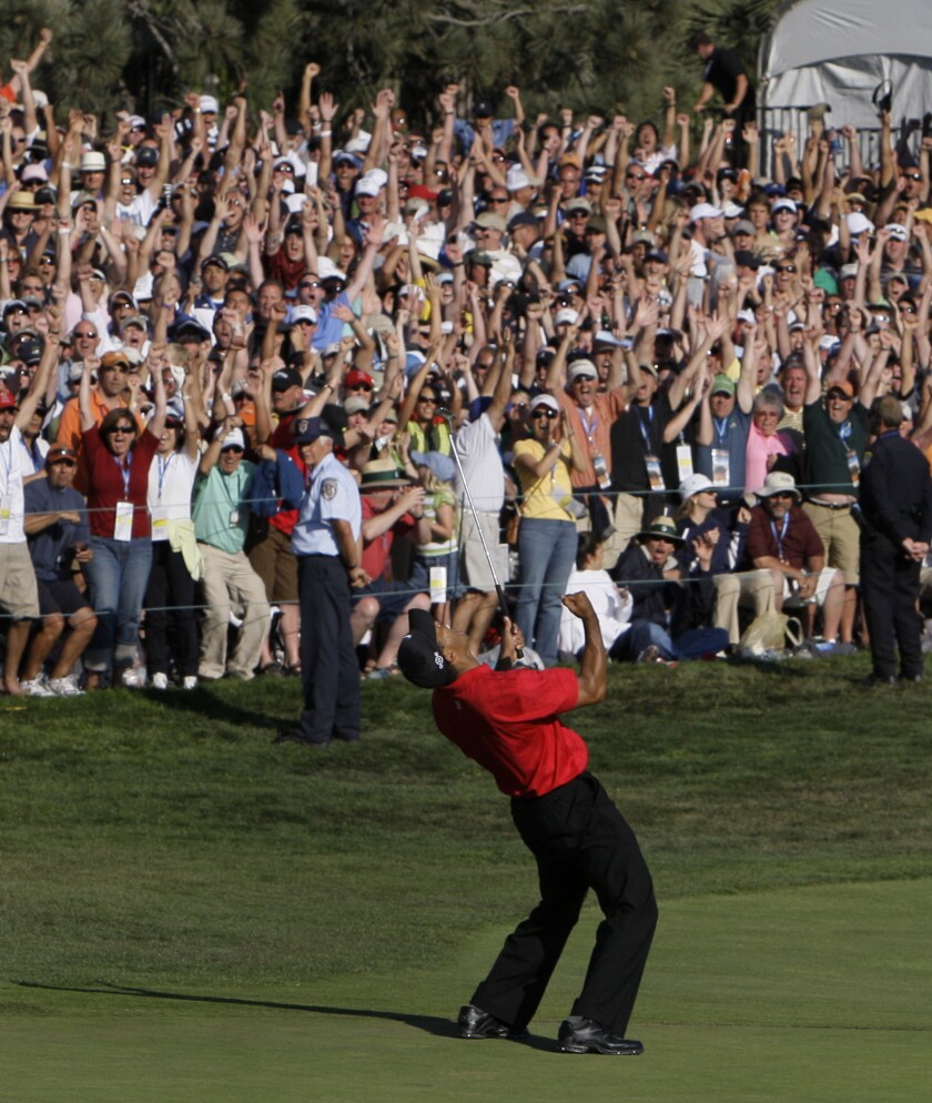 FILE - In this June 15, 2008, file photo, Tiger Woods reacts after sinking a birdie putt on the 18th green, forcing a playoff against Rocco Mediate during the fourth round of the U.S. Open golf tournament at Torrey Pines Golf Course in San Diego. The U.S. Open returns to Torrey Pines on June 17-20, minus Woods as he recovers from leg injuries in a car crash. (AP Photo/Chris Carlson, File)