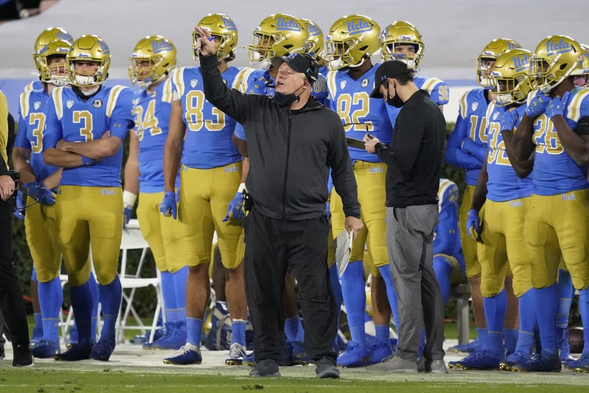 UCLA coach Chip Kelly signals from the sideline during a game against Arizona on Nov. 28.