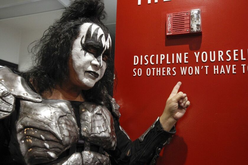 SAN DIEGO, February 7, 2019 | Kiss bass player Gene Simmons points to writing on a wall during a meet and greet with fans before the start of the"End of the Road World Tour" farewell concert at the Viejas Arena in San Diego on Thursday. | Photo by Hayne Palmour IV/San Diego Union-Tribune/Mandatory Credit: HAYNE PALMOUR IV/SAN DIEGO UNION-TRIBUNE/ZUMA PRESS San Diego Union-Tribune Photo by Hayne Palmour IV copyright 2019