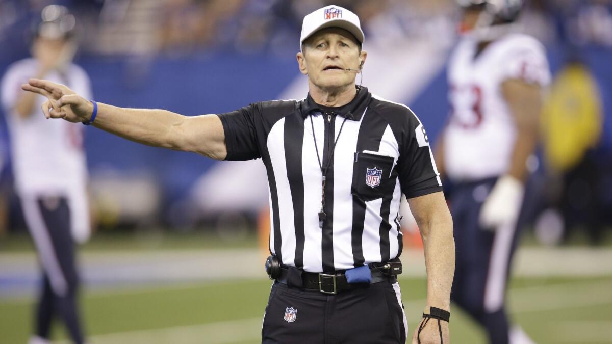 Referee Ed Hochuli makes a call during the first half of an NFL football game between the Indianapolis Colts and the Houston Texans in 2015.