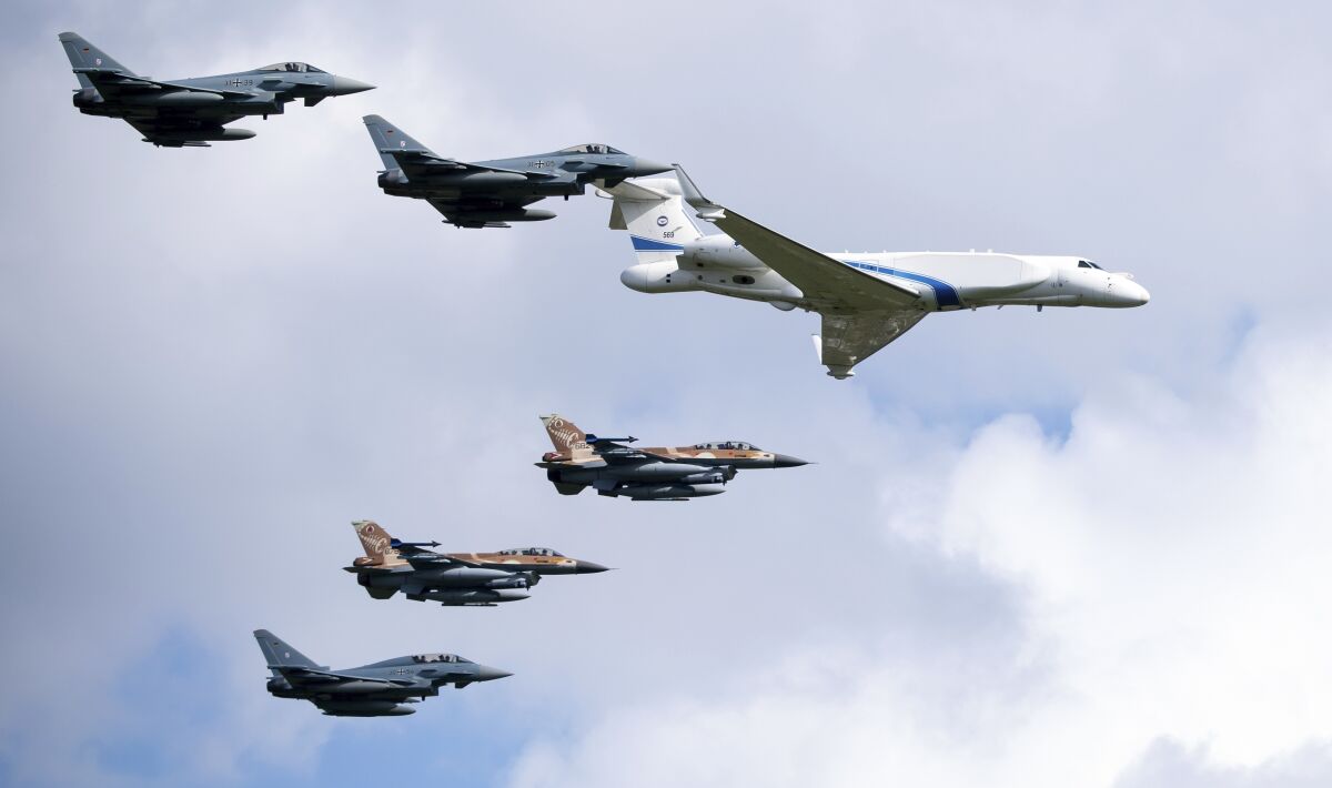 German air force Bundeswehr Eurofighters and an Israeli Air Force jets fly in formation over the Fuerstenfeldbruck airbase in commemoration of the 1972 Olympic Games assassination attempt in Fuerstenfeldbruck, Germany, Tuesday, Aug. 18, 2020. The attempt to rescue the hostages failed at the airbase in Fuerstenfeldbruck in 1972and the hostages perished. It is the Israeli Air Force's first time conducting joint air combat exercises in Germany. (Sven Hoppe/dpa via AP)