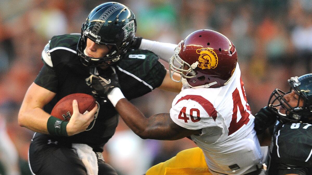 USC linebacker Jabari Ruffin tries to bring down Hawaii quarterback Taylor Graham during the Trojans' win on Aug. 29, 2013.