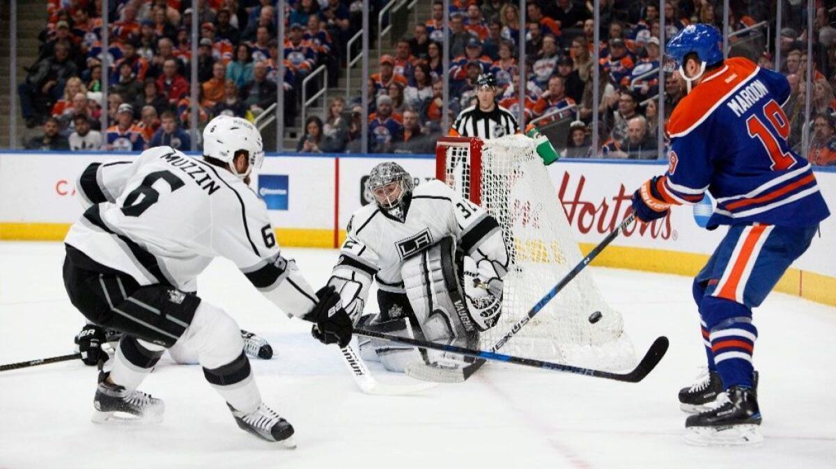 Oilers' Patrick Maroon (19) can't get a shot past Kings goaltender Jonathan Quick (32) as Jake Muzzin (6) defends during the second period on March 20.