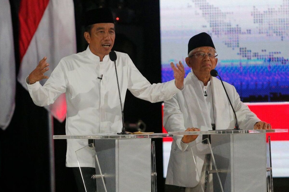 Indonesian President Joko Widodo, left, appears with running mate Ma'ruf Amin during a televised debate on April 13, 2019.