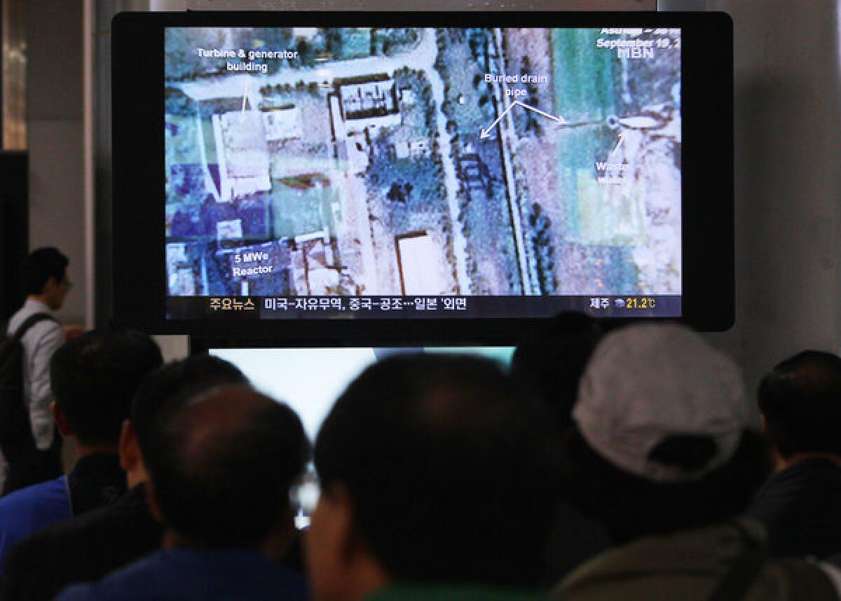 South Koreans at the Seoul Railway Station watch a television broadcast of satellite imagery from North Korea's Yongbyon nuclear site, where the reactor was restarted recently, according to Seoul's National Intelligence Service.