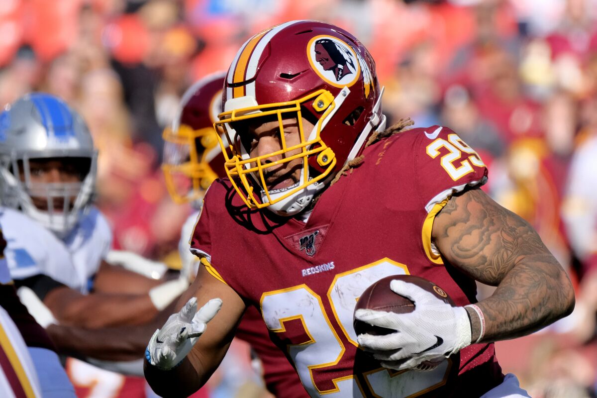 FILE - In this Nov. 24, 2019, file photo, Washington Redskins running back Derrius Guice (29) runs the ball during an NFL football game against the Detroit Lions in Landover, Md. The Washington Football Team has released Guice after he was charged in a domestic violence incident. (AP Photo/Mark Tenally, File)