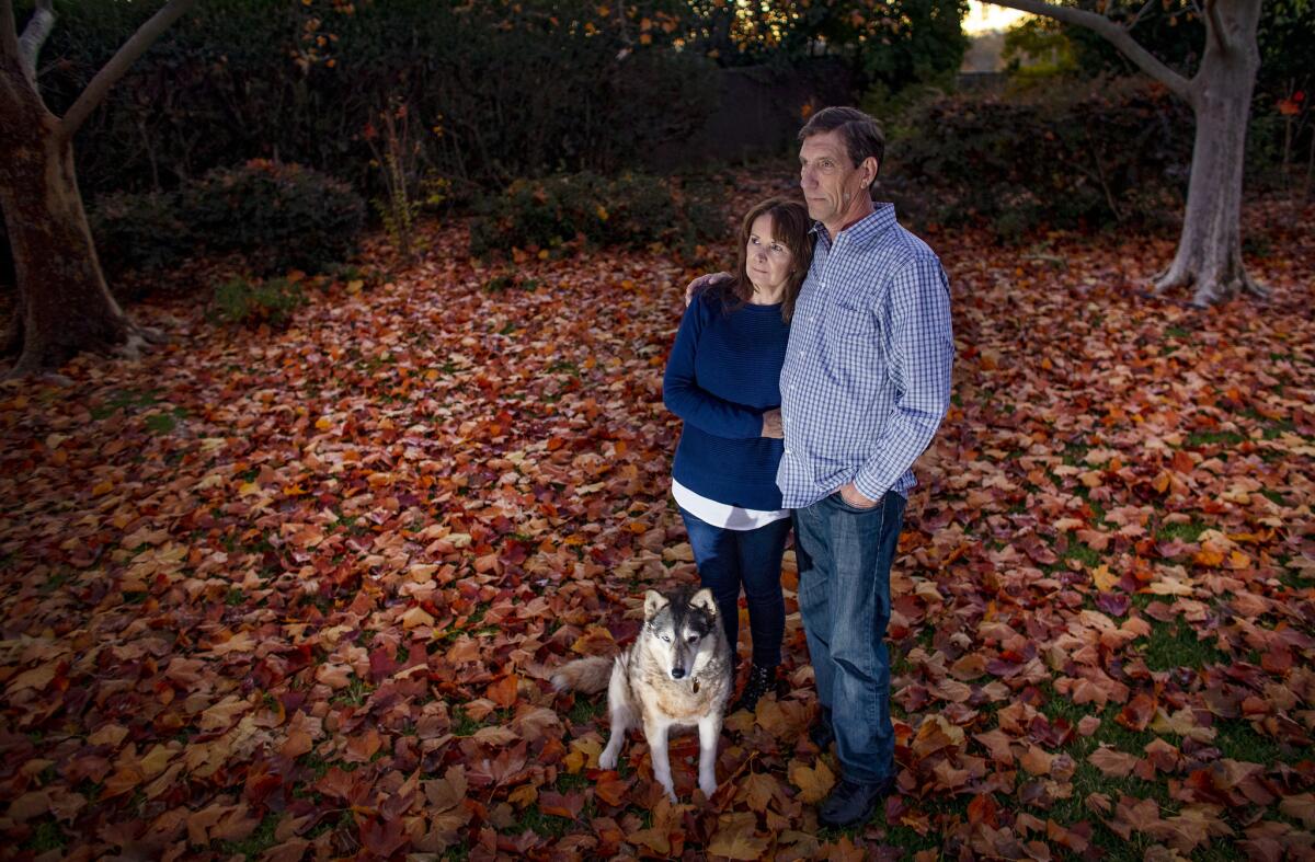 David Demaree with his wife, Kathy, and dog, Fayla. Demaree thought about joining the evacuees at the parking lot but couldn't lead Fayla while juggling the cat carrier along with backpacks filled with memories.