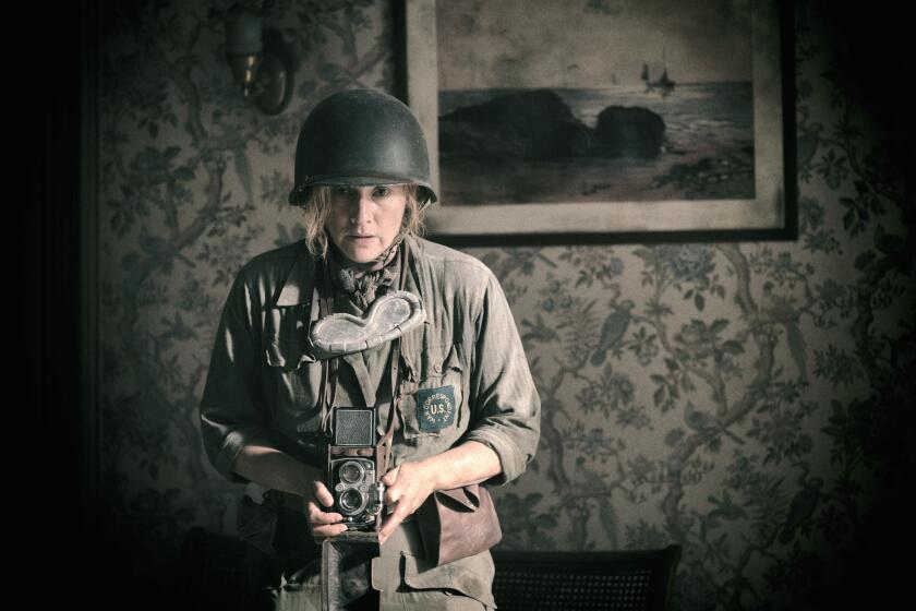 A woman in a helmet takes a photograph.