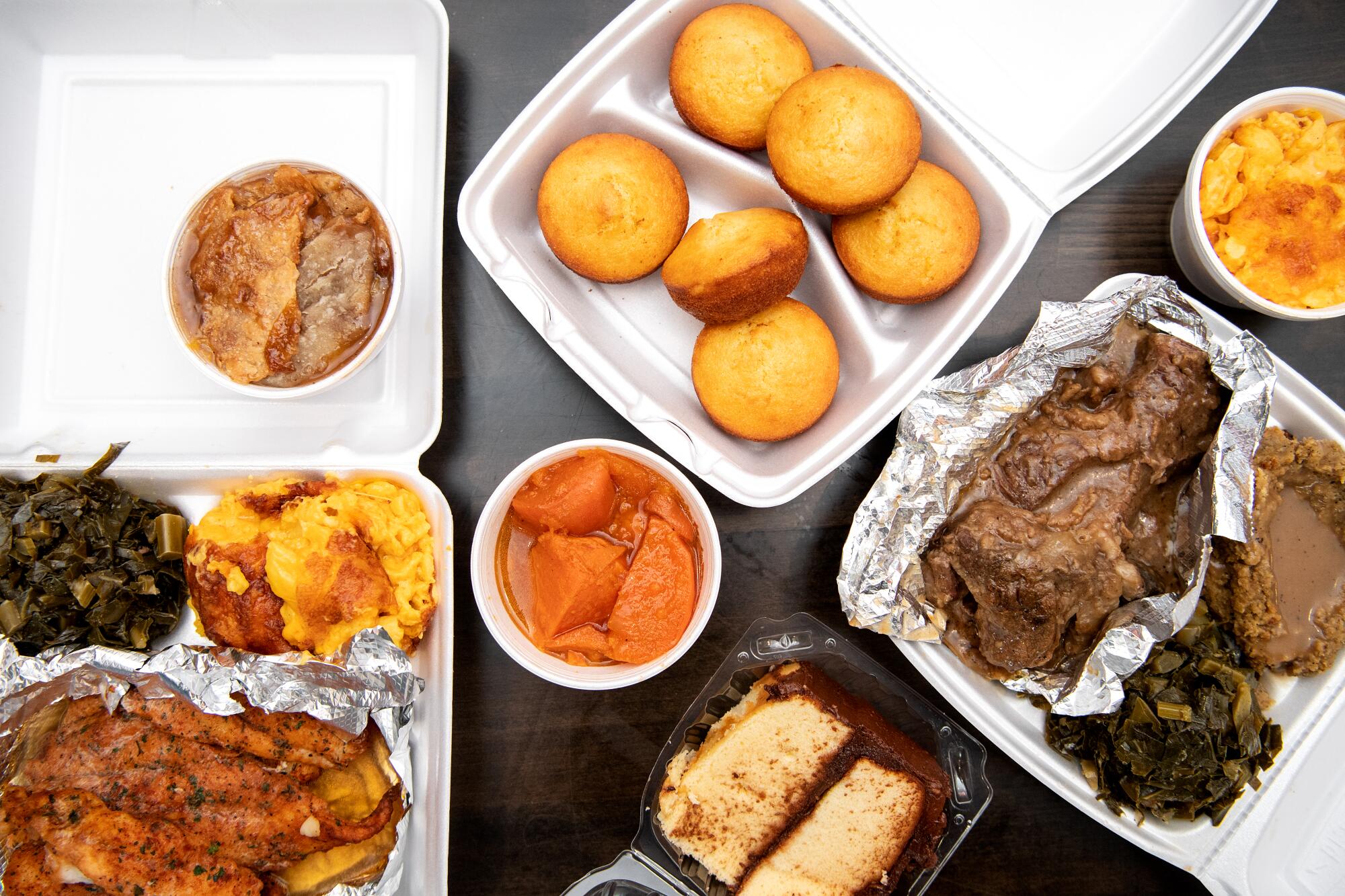 A spread from Dulan's includes corn muffins, yams, short rib and more.