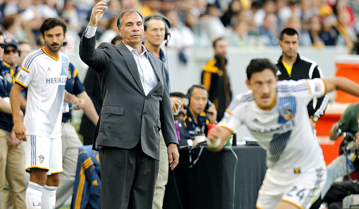 Coach Bruce Arena watches the Galaxy play the Seattle Sounders in the first leg of a two-game series for the Western Conference title. L.A. won the game, 1-0.