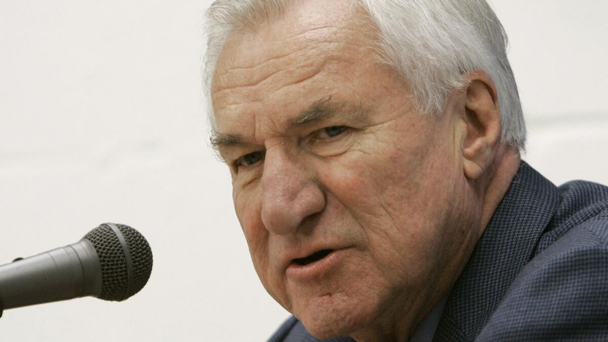Former North Carolina men's basketball coach Dean Smith answers questions during a news conference in Chapel Hill, N.C., in December 2006. Smith, considered one of the greatest coaches in college basketball history, died Saturday.